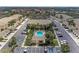 Aerial view of a community with a pool surrounded by lush landscaping and ample parking at 6326 Grand Oak Cir # 203, Bradenton, FL 34203