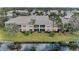 Back view of condo, showing lush green backyard and water feature at 6326 Grand Oak Cir # 203, Bradenton, FL 34203