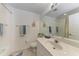 Bright bathroom features a large mirror, sink, and walk-in shower with white tile walls at 6326 Grand Oak Cir # 203, Bradenton, FL 34203