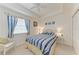 Comfortable bedroom with blue striped bedding and coastal decor at 6326 Grand Oak Cir # 203, Bradenton, FL 34203