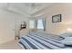 Bright bedroom with a white door, neutral carpet, and a blue striped bedspread at 6326 Grand Oak Cir # 203, Bradenton, FL 34203