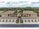 Aerial view of condo exterior and garages in a well-maintained community with mature trees at 6326 Grand Oak Cir # 203, Bradenton, FL 34203