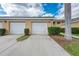 Attached one car garage and driveway with tidy landscaping and blue skies at 6326 Grand Oak Cir # 203, Bradenton, FL 34203