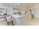 Well-lit kitchen with white cabinetry, sleek countertops, and bar seating, ideal for casual dining and entertaining at 6326 Grand Oak Cir # 203, Bradenton, FL 34203