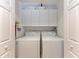 Laundry room features a side-by-side washer and dryer and overhead cabinet storage at 6326 Grand Oak Cir # 203, Bradenton, FL 34203
