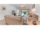 Cozy living room with comfortable seating, natural light, and access to an outdoor patio, perfect for relaxing at 6326 Grand Oak Cir # 203, Bradenton, FL 34203
