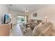 Bright living room with a ceiling fan, comfortable furniture, and sliding door access to the patio at 6326 Grand Oak Cir # 203, Bradenton, FL 34203