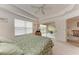 Bright bedroom features a ceiling fan and sliding glass doors to a covered patio at 6326 Grand Oak Cir # 203, Bradenton, FL 34203
