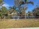 Backyard overlooking a serene pond, framed by mature trees and lush greenery at 6704 35Th W Ave, Bradenton, FL 34209