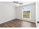 Cozy bedroom with wood-look floors, ceiling fan, and window overlooking the street at 6704 35Th W Ave, Bradenton, FL 34209