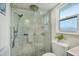 Bathroom featuring glass-enclosed shower with tiled walls, providing a luxurious and modern experience at 7115 11Th W Ave, Bradenton, FL 34209