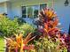 Detailed view of colorful landscaping with a decorative bird sculpture at 7115 11Th W Ave, Bradenton, FL 34209