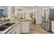 Open concept living space featuring views into the kitchen with stainless refrigerator at 7115 11Th W Ave, Bradenton, FL 34209