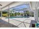 Screened-in pool area with paved deck, lush landscaping, lounge chairs, and clear blue water at 7115 11Th W Ave, Bradenton, FL 34209
