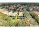 Aerial view of a single-Gathering home with a screened-in pool and lush landscaping at 7305 Birds Eye Ter, Bradenton, FL 34203