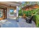 Charming front porch with comfortable seating, lush greenery, and a stylish umbrella for shade at 7825 Troon Ct, Lakewood Ranch, FL 34202