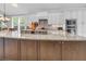 Spacious kitchen island with granite countertops, custom cabinets, and modern fixtures at 7825 Troon Ct, Lakewood Ranch, FL 34202