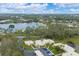 Scenic aerial view of a lakeside community with manicured lawns, mature trees, and inviting residential buildings at 801 Spring Lakes Blvd # 801, Bradenton, FL 34210