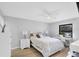 Bedroom with light gray walls, ceiling fan, and desk under window at 801 Spring Lakes Blvd # 801, Bradenton, FL 34210