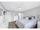 Bright bedroom with light gray walls, ceiling fan, and two closets at 801 Spring Lakes Blvd # 801, Bradenton, FL 34210