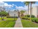 Charming single-story villa with a well-manicured lawn and walkway leading to the front door at 801 Spring Lakes Blvd # 801, Bradenton, FL 34210