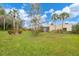 Home exterior with well maintained landscaping and mature palm trees at 801 Spring Lakes Blvd # 801, Bradenton, FL 34210