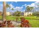 Lush landscaping frames this home's back yard, with mature trees and flowering shrubs at 801 Spring Lakes Blvd # 801, Bradenton, FL 34210