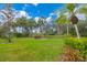 Well-manicured front yard with lush green grass, shrubs, and trees at 801 Spring Lakes Blvd # 801, Bradenton, FL 34210