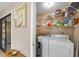 Convenient laundry room featuring full-size washer and dryer and shelving at 801 Spring Lakes Blvd # 801, Bradenton, FL 34210