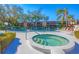 Relaxing pool area featuring a large swimming pool, a jacuzzi, lounge chairs, and umbrellas for community enjoyment at 801 Spring Lakes Blvd # 801, Bradenton, FL 34210