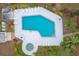 Aerial view of a large pool and jacuzzi surrounded by sun loungers and lush landscaping at 801 Spring Lakes Blvd # 801, Bradenton, FL 34210