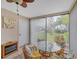 Cozy sunroom with lots of light, seating, and view of back yard and landscaping at 801 Spring Lakes Blvd # 801, Bradenton, FL 34210