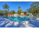 Sparkling community pool with ample seating, shaded areas, and beautiful landscaping for relaxation and enjoyment at 801 Spring Lakes Blvd # 801, Bradenton, FL 34210