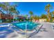 Community pool with lush landscaping, comfortable lounge chairs, and clear blue water, perfect for relaxation and recreation at 801 Spring Lakes Blvd # 801, Bradenton, FL 34210