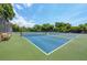 Outdoor tennis courts with green and blue surfaces and mature shade trees in the background at 801 Spring Lakes Blvd # 801, Bradenton, FL 34210