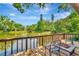 Outdoor living space with wood deck overlooking peaceful pond at 805 Mcarthur Ave, Sarasota, FL 34243