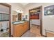 Bathroom featuring oak cabinetry, a toilet, walk-in closet, and vintage accents at 805 Mcarthur Ave, Sarasota, FL 34243