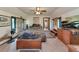 Bedroom with tiled floor, ceiling fan, leafy comforter set, and driftwood art at 805 Mcarthur Ave, Sarasota, FL 34243