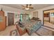 Bedroom with tiled floor, ceiling fan, and a bed dressed in a leafy comforter set at 805 Mcarthur Ave, Sarasota, FL 34243