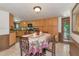Dining room with wood accents and adjacent kitchen at 805 Mcarthur Ave, Sarasota, FL 34243