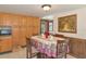 Cozy dining room with adjacent kitchen, wood accents and adjacent doorway to exterior at 805 Mcarthur Ave, Sarasota, FL 34243