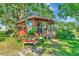 Charming exterior view of a home with decorative plantings and a butterfly decoration, surrounded by lush greenery at 805 Mcarthur Ave, Sarasota, FL 34243
