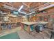 Well-organized garage features a large workbench, tool storage, television, and ample space for various projects at 805 Mcarthur Ave, Sarasota, FL 34243
