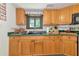Kitchen featuring green countertops, stainless steel appliances and light wood cabinets at 805 Mcarthur Ave, Sarasota, FL 34243