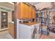Functional laundry room with washer, dryer, cabinetry, adjacent to walk-in closet at 805 Mcarthur Ave, Sarasota, FL 34243