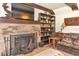 Stone fireplace and decorative shelving enhance this cozy living area at 805 Mcarthur Ave, Sarasota, FL 34243