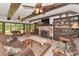 Comfortable living room with beamed ceilings, fireplace, and a view of the outdoor scenery at 805 Mcarthur Ave, Sarasota, FL 34243