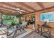 Cozy covered patio featuring a ceiling fan, lounge furniture, and tranquil outdoor views at 805 Mcarthur Ave, Sarasota, FL 34243
