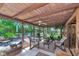 Inviting covered porch with beamed ceiling, lounge seating, and access to the outdoor greenery at 805 Mcarthur Ave, Sarasota, FL 34243