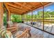 Relaxing screened porch with outdoor seating and a view of the serene waterfront at 805 Mcarthur Ave, Sarasota, FL 34243